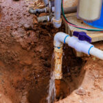 water pipe leaking in excavated brown dirt 2026 01 09 08 09 30 utc